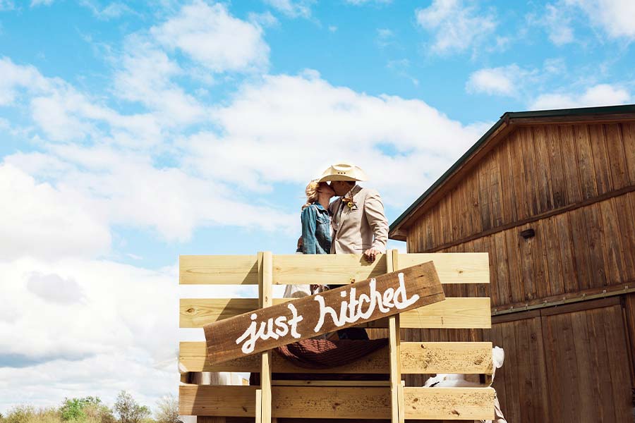 Bride & Groom Kissing Just Hitched Wagon